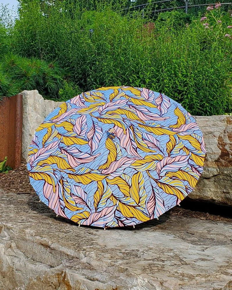 phosphosiderite handmade parasol exterior, medium size, with afro-inspired design on a stone slab