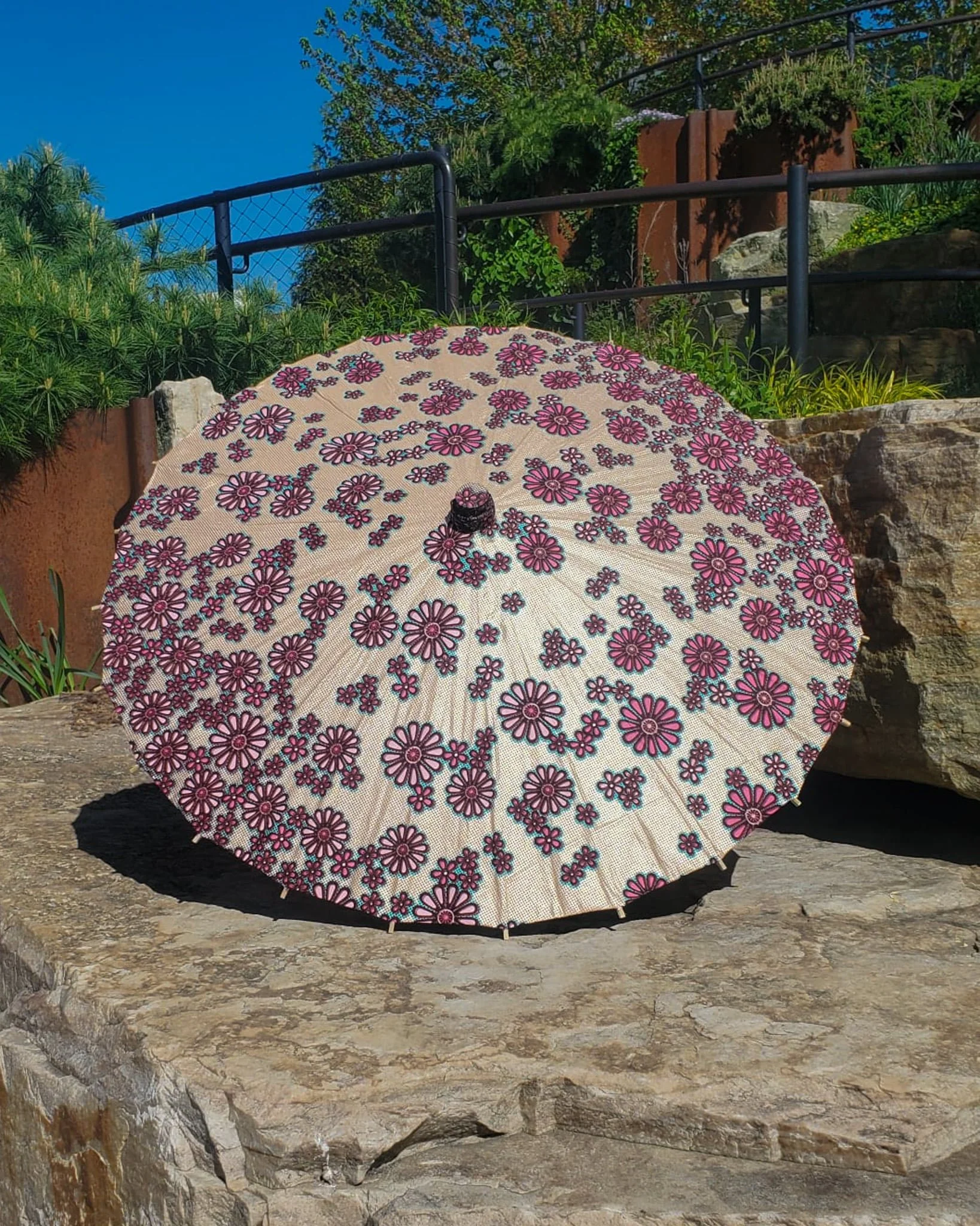 rhodochrosite handmade parasol exterior, medium size, with afro-inspired design on a stone slab