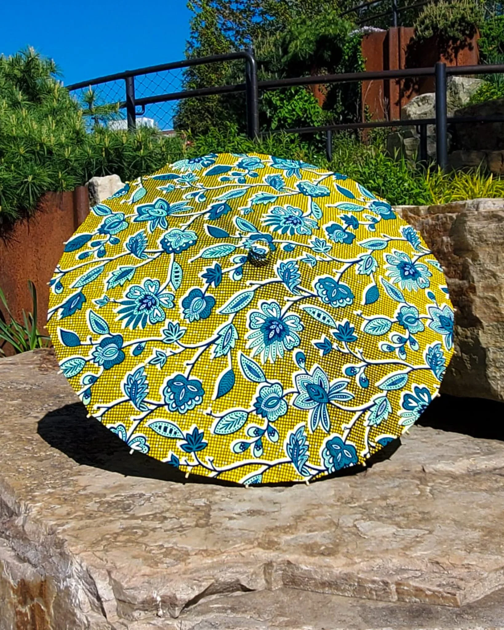 labradorite handmade parasol exterior, medium size, with afro-inspired design on a stone slab