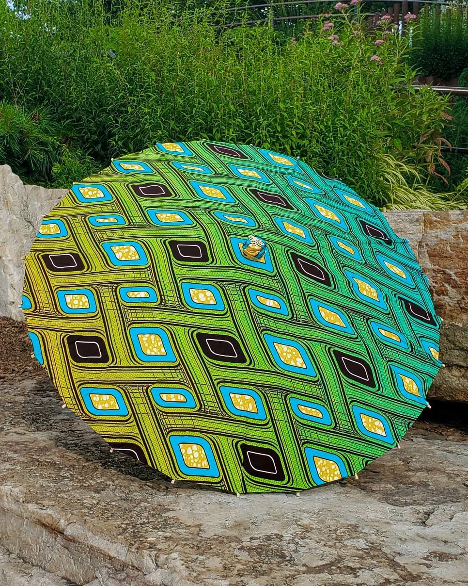 gaspeite handmade parasol exterior, medium size, with afro-inspired design on a stone slab