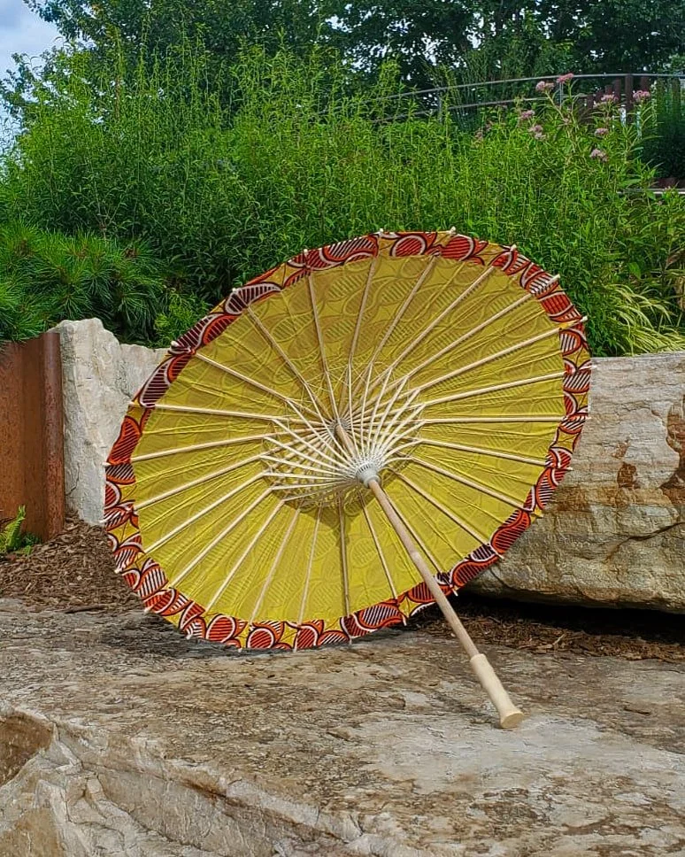 amber handmade parasol interior, medium sized, with afro-inspired design on a stone slab