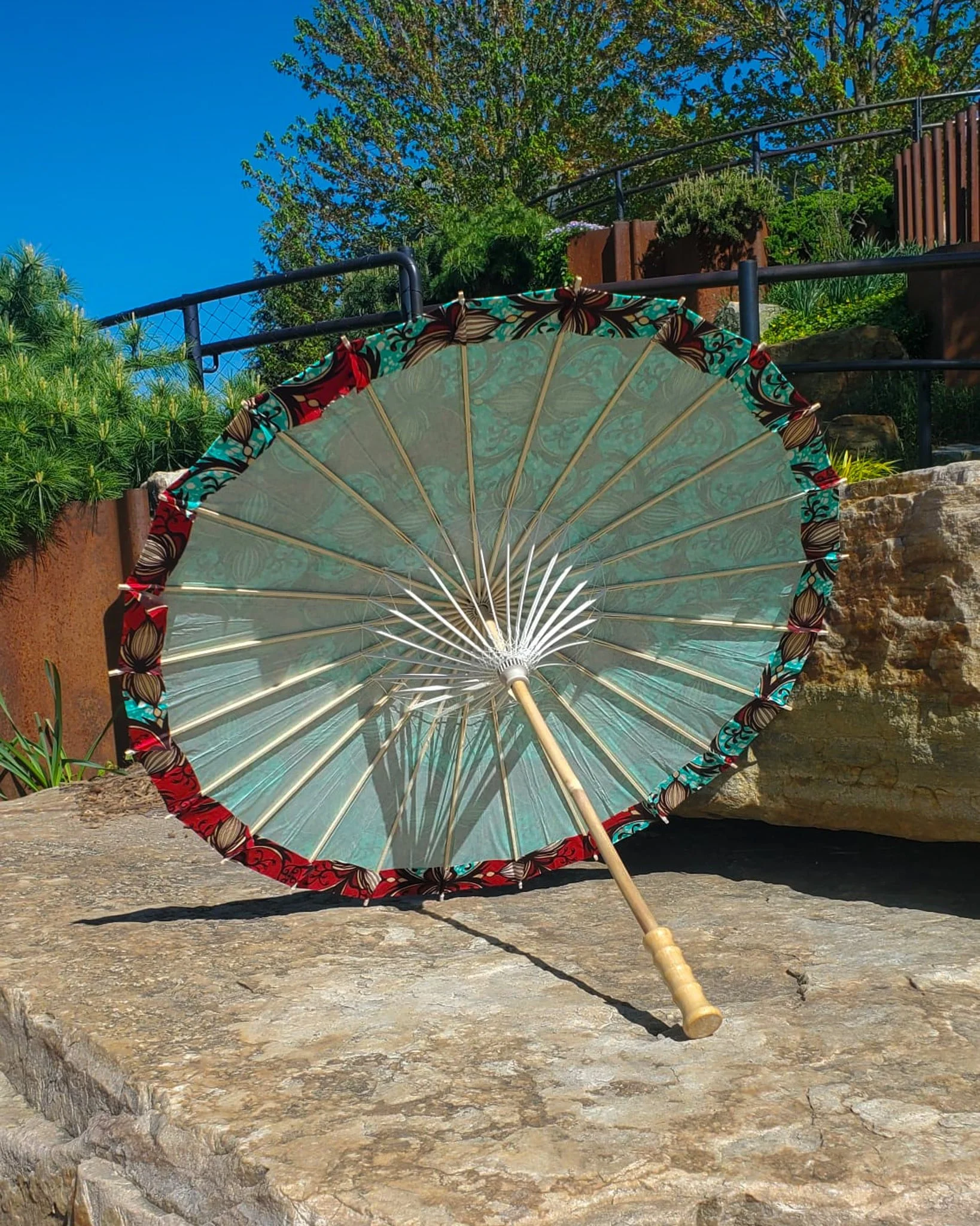 chrysocolla handmade parasol interior, medium size, with afro-inspired design on a stone slab