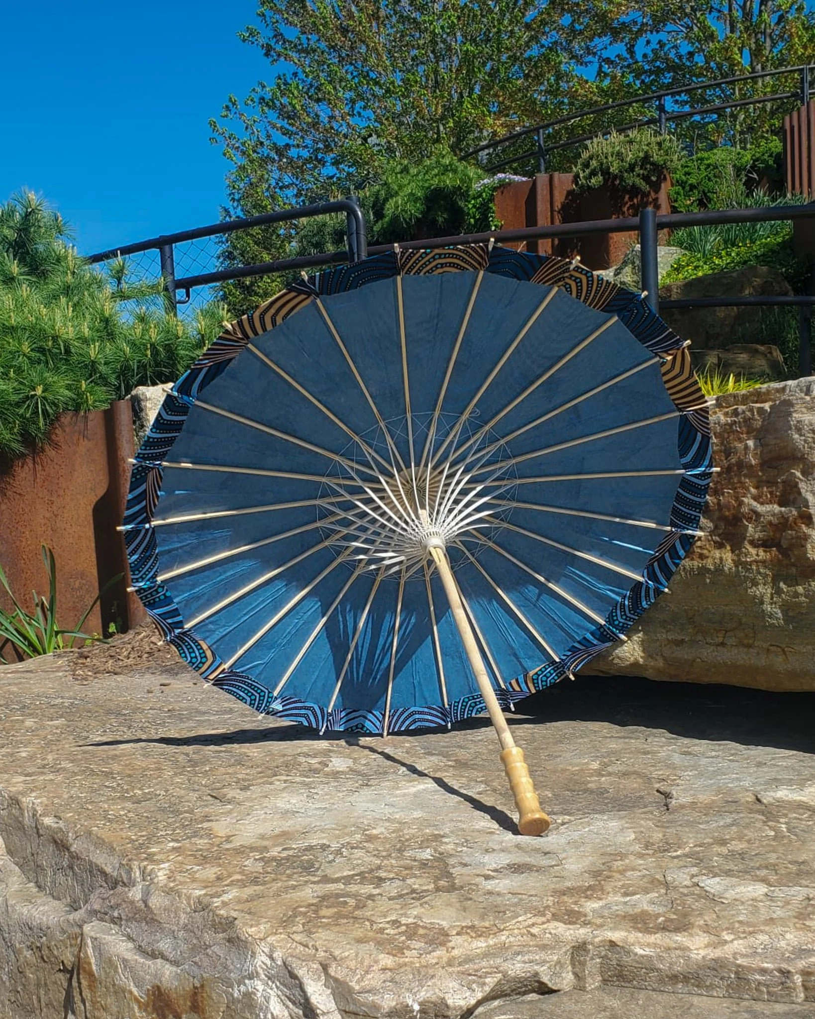 dumortierite handmade parasol interior, medium size, with afro-inspired design on a stone slab