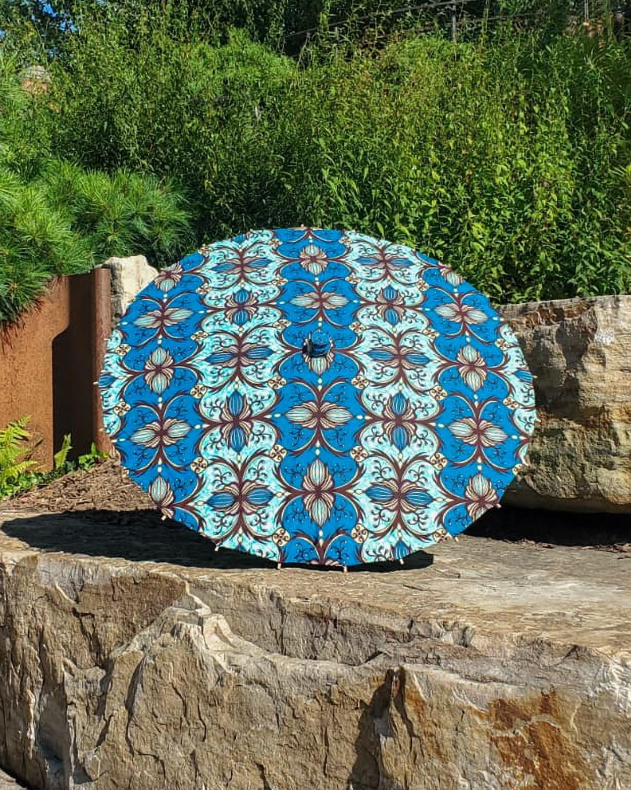 blue apatite hand made parasol exterior, medium size, with afro-inspired design on a stone slab