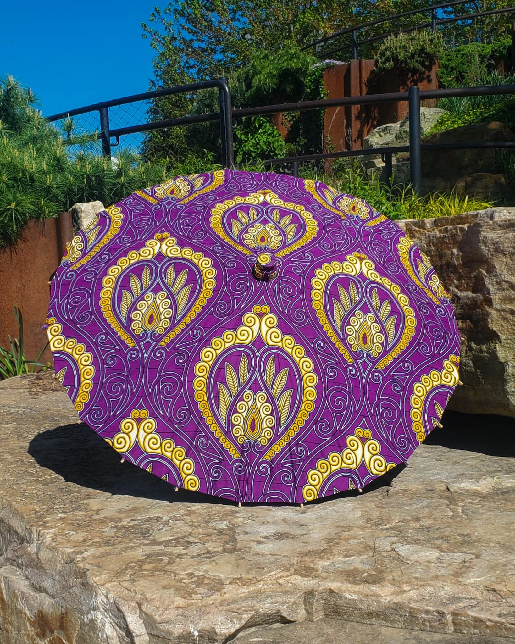 coquimbite handmade parasol exterior, medium size, with afro-inspired design on a stone slab