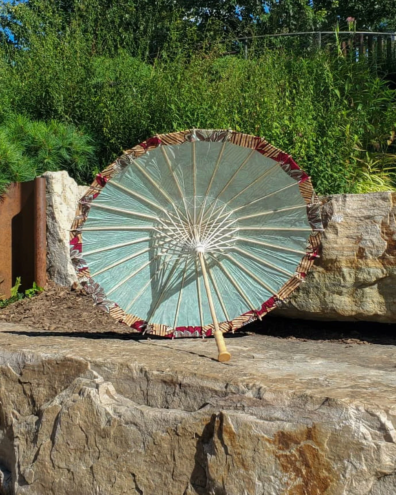 strawberry opal handmade parasol interior, medium size, with afro-inspired design on a stone slab