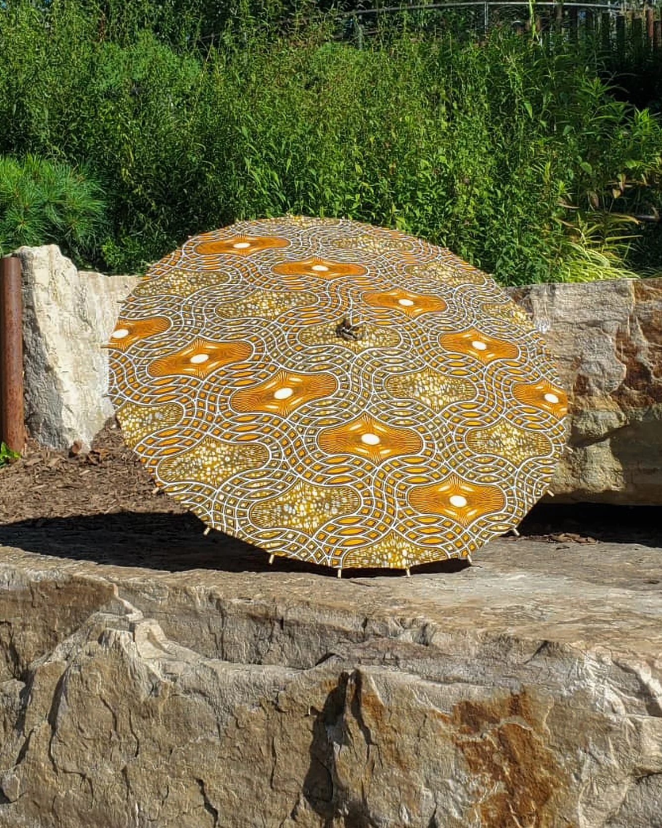 skeletal quartzhandmade parasol exterior, medium size, with afro-inspired design on a stone slab