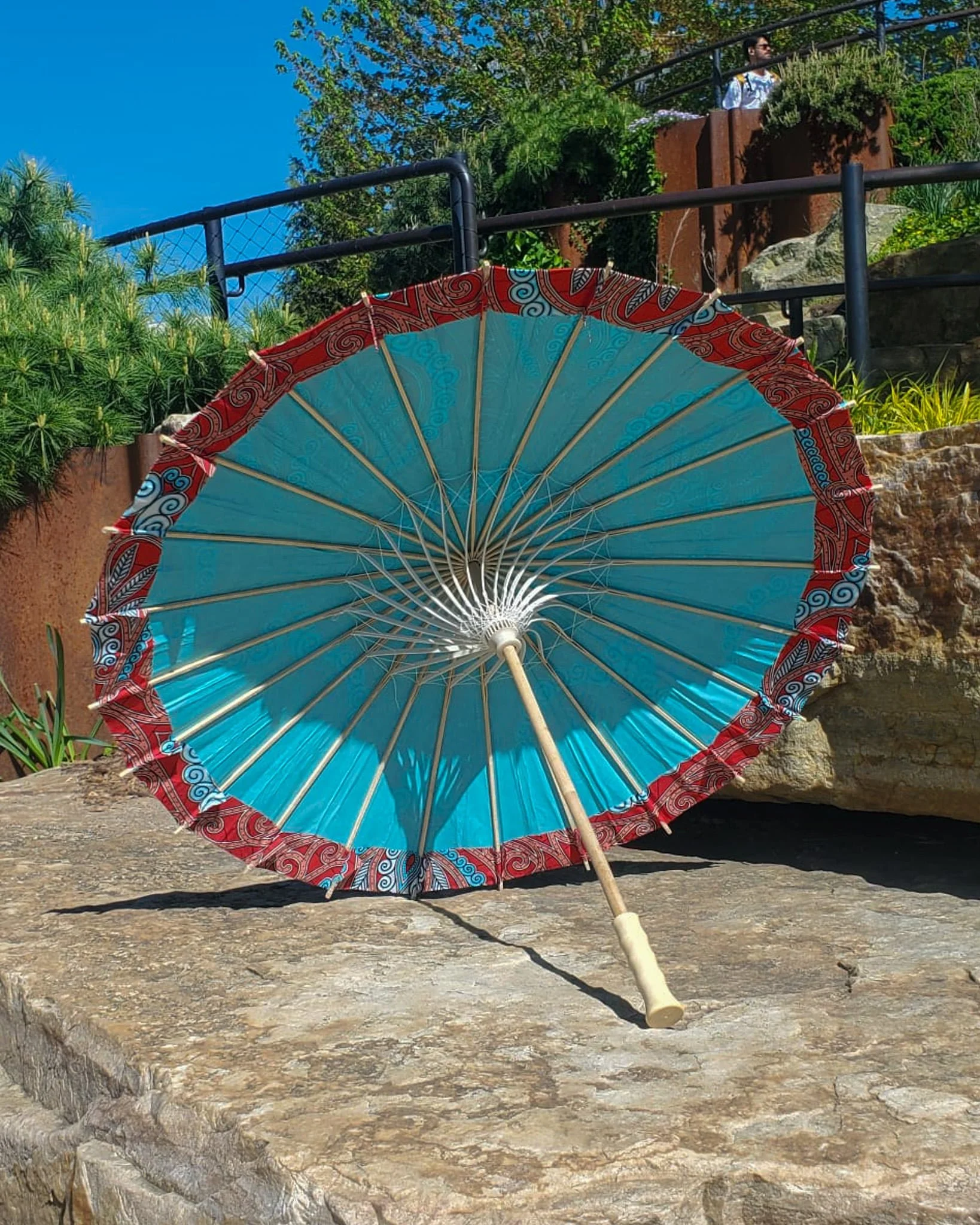 sonora sunrise handmade parasol interior, medium size, with afro-inspired design on a stone slab