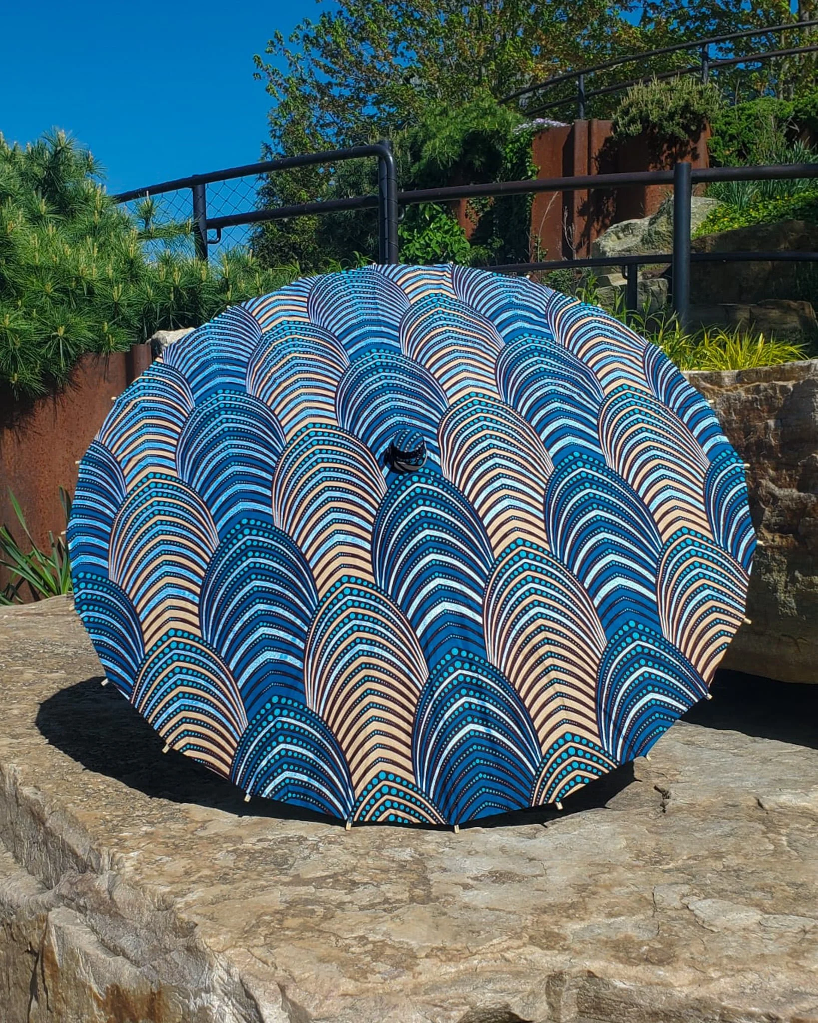 dumortierite handmade parasol exterior, medium size, with afro-inspired design on a stone slab