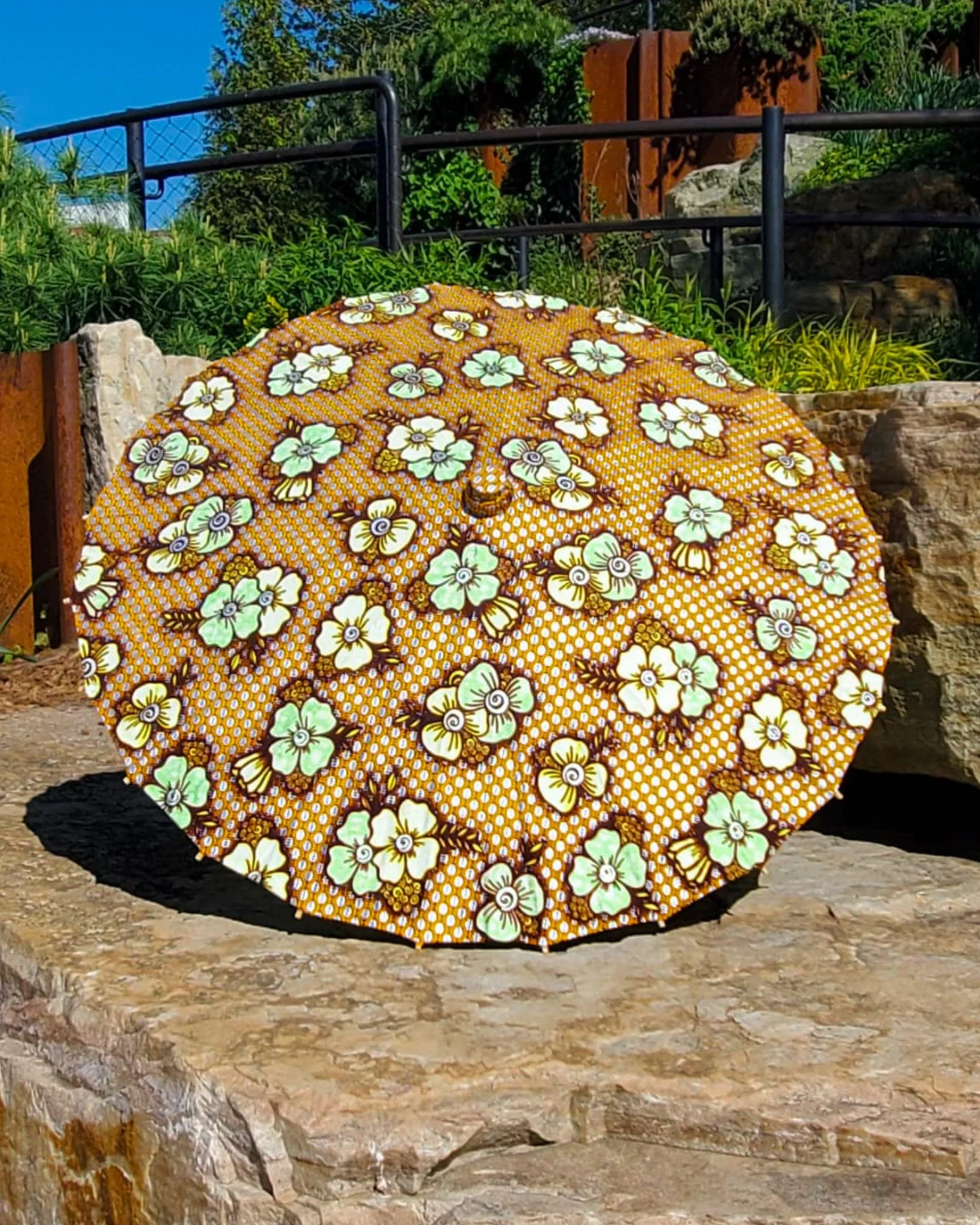 lions gate quartz handmade parasol exterior, medium size, with afro-inspired design on a stone slab