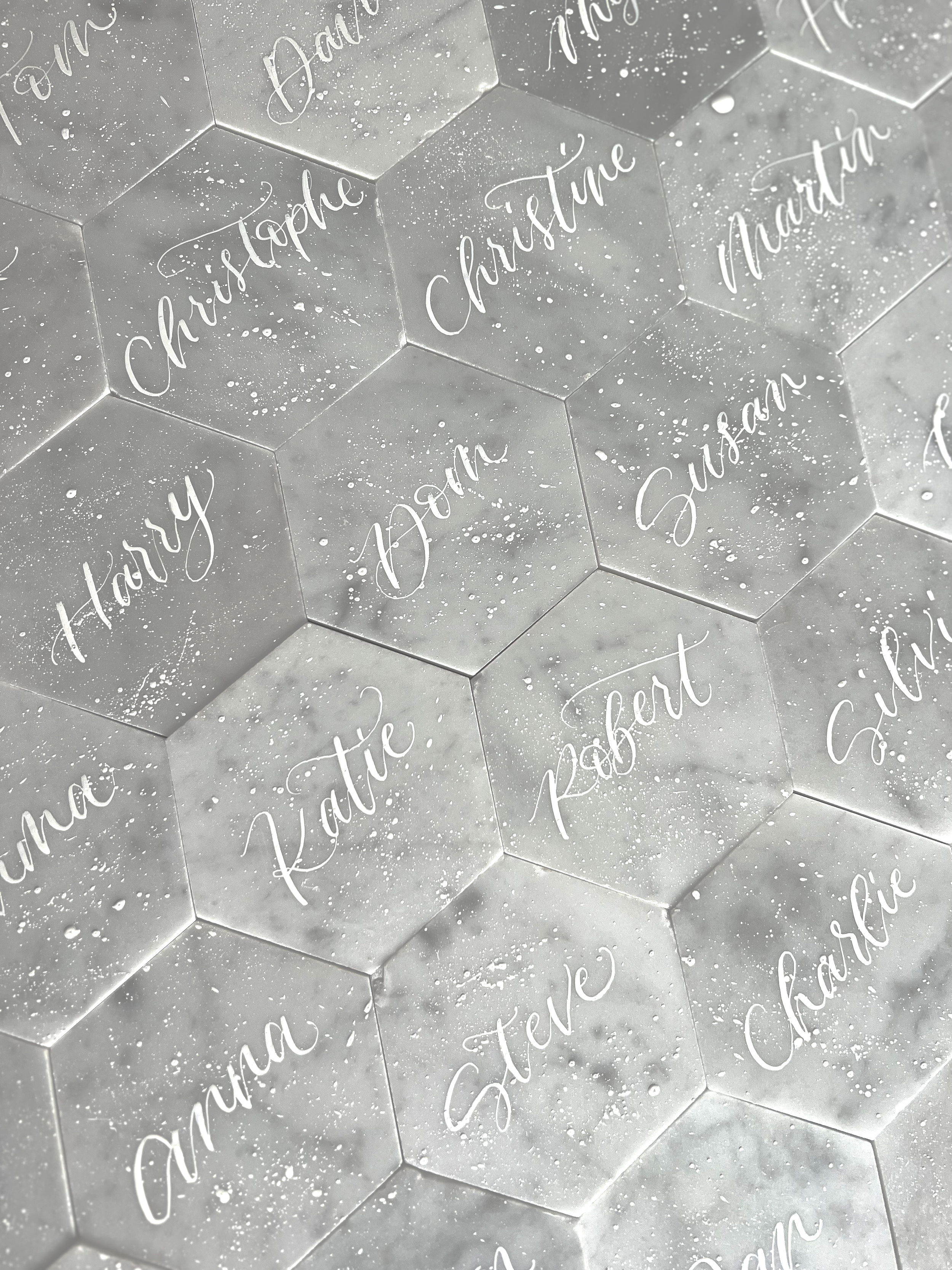 Marble tile place settings with white ink calligraphy and splattered effect