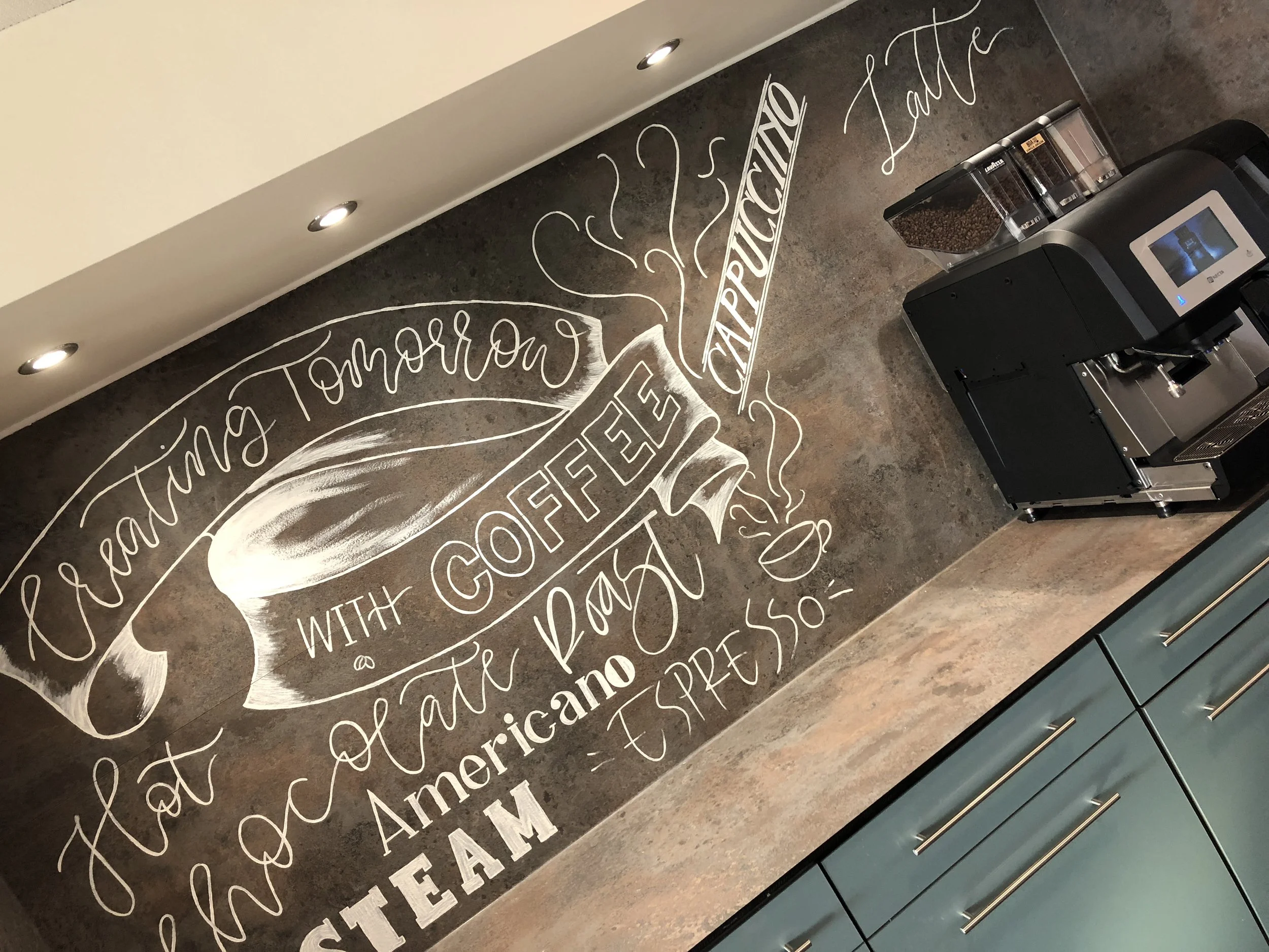 Coffee station murals painted on tile across two floors 