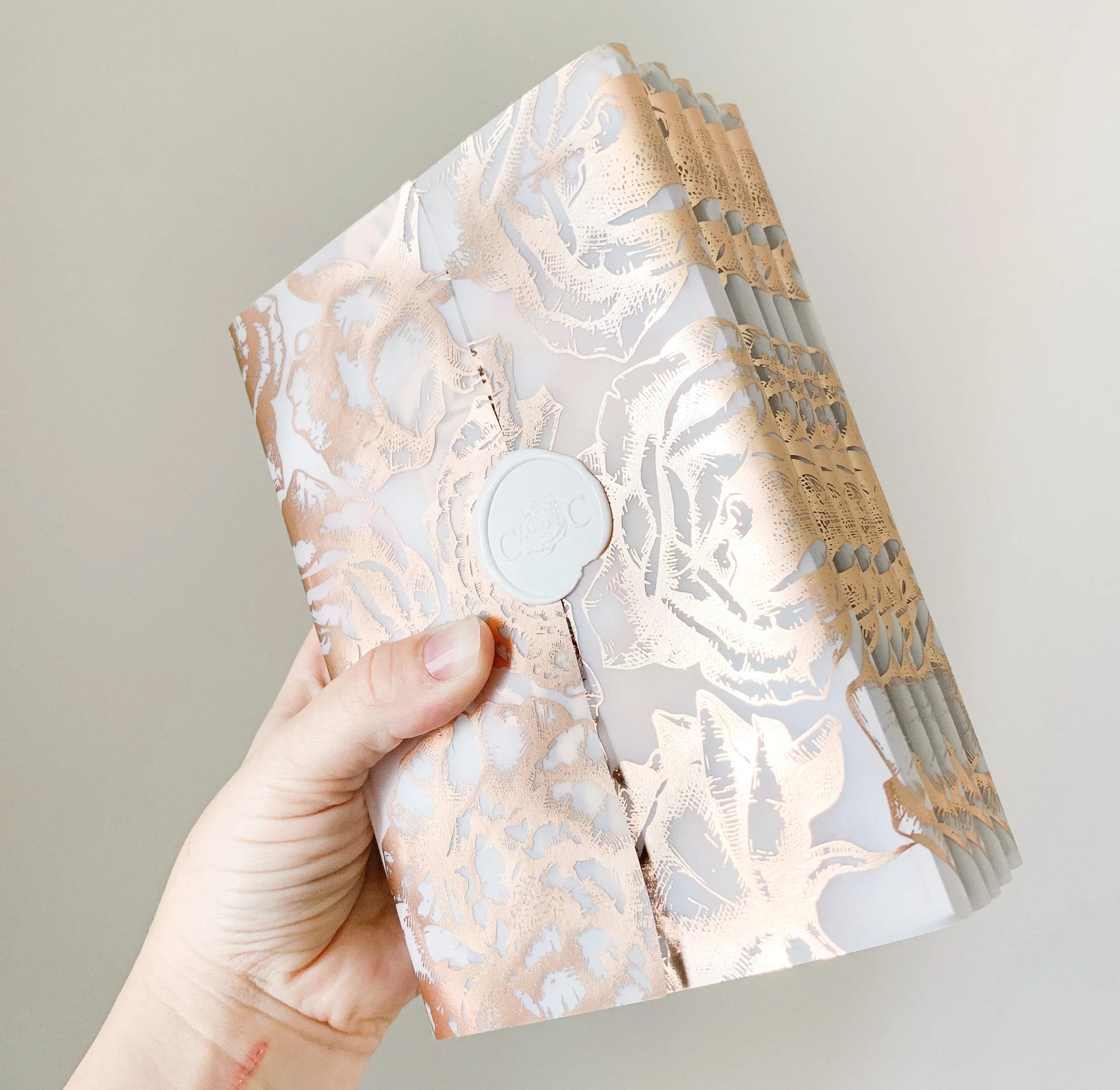 Wrap the acrylic sandwich invitation with rose gold printed vellum and finished with a wax seal - such a thick, heavy invitation to open