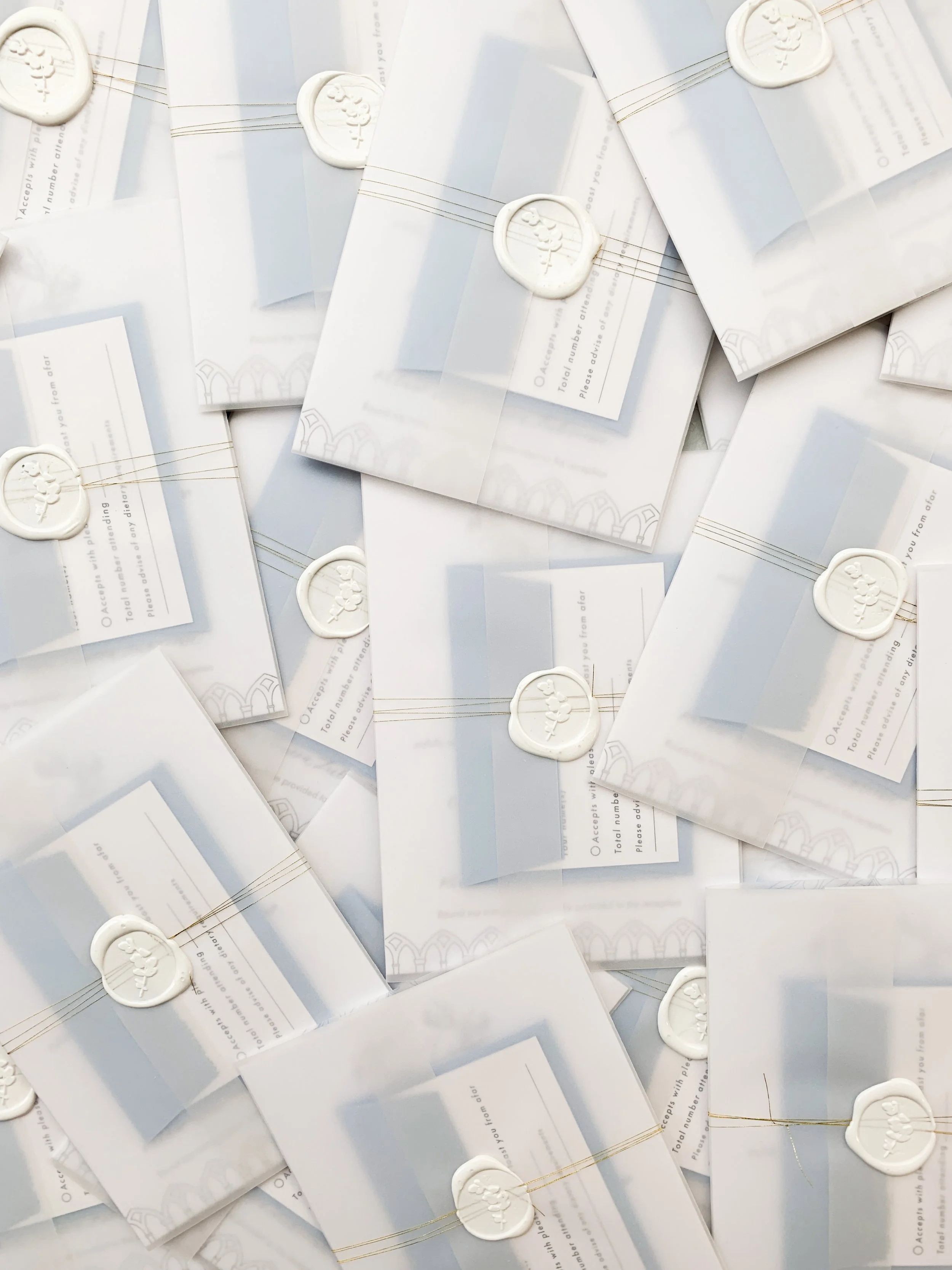 Letterpress invitations, info card and RSVP wrapped in vellum finished with a wax seal and thread