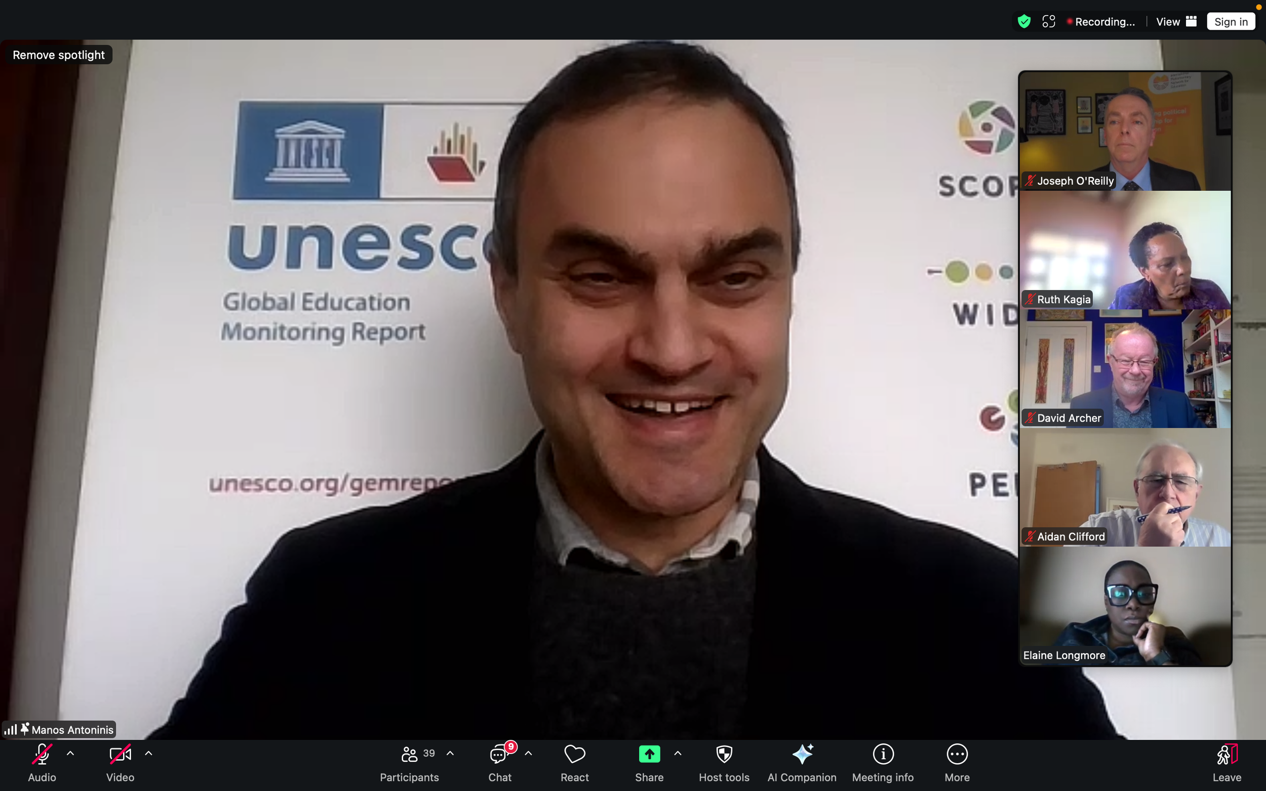Screenshot of a Zoom call. The main speaker is smiling as he presents slides with Unesco branding, while other speakers listen.