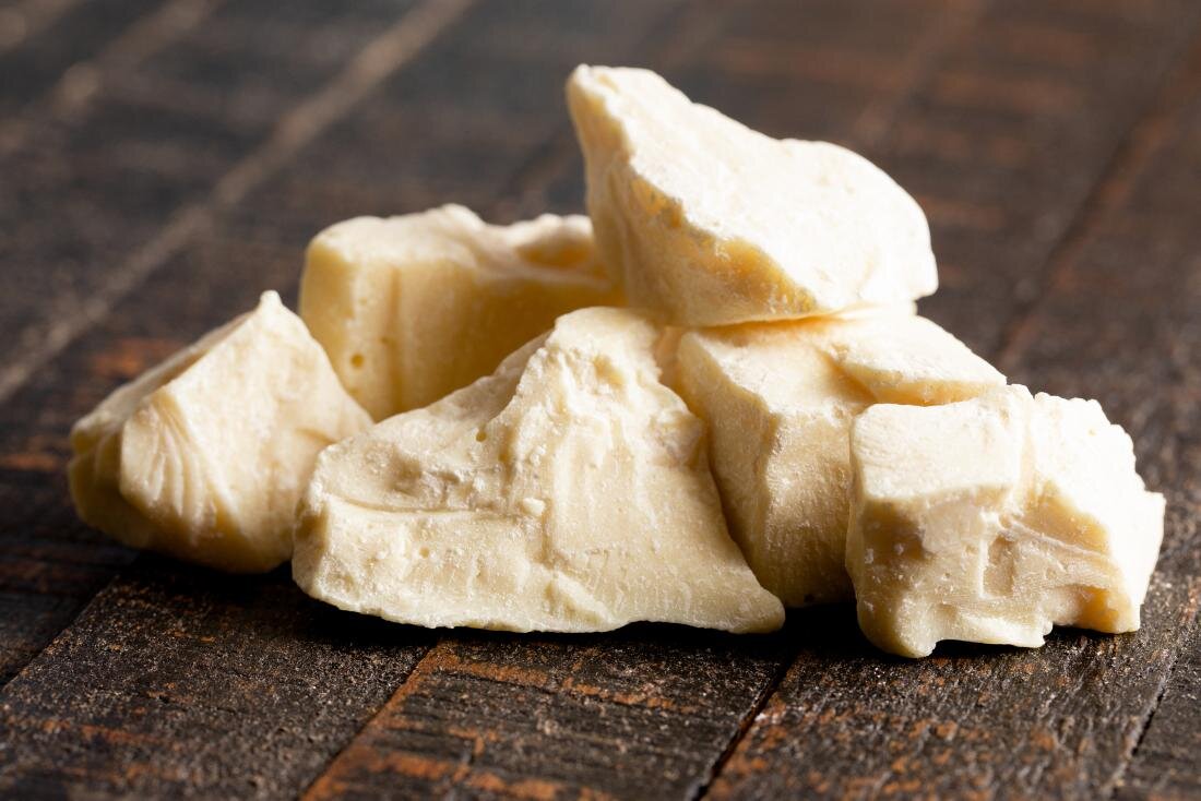 chunks-of-cocoa-butter-on-wooden-surface.jpg