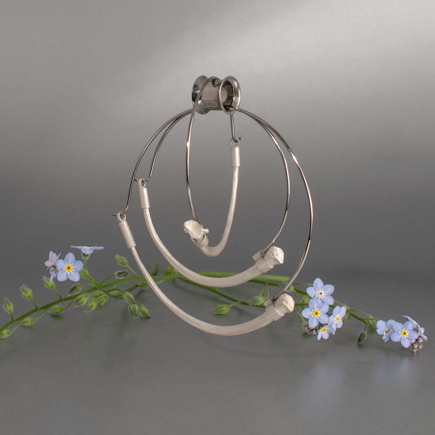 Medium and Large tunnel earrings with a python rib cast in sterling silver and a hypoallergenic titanium clasp