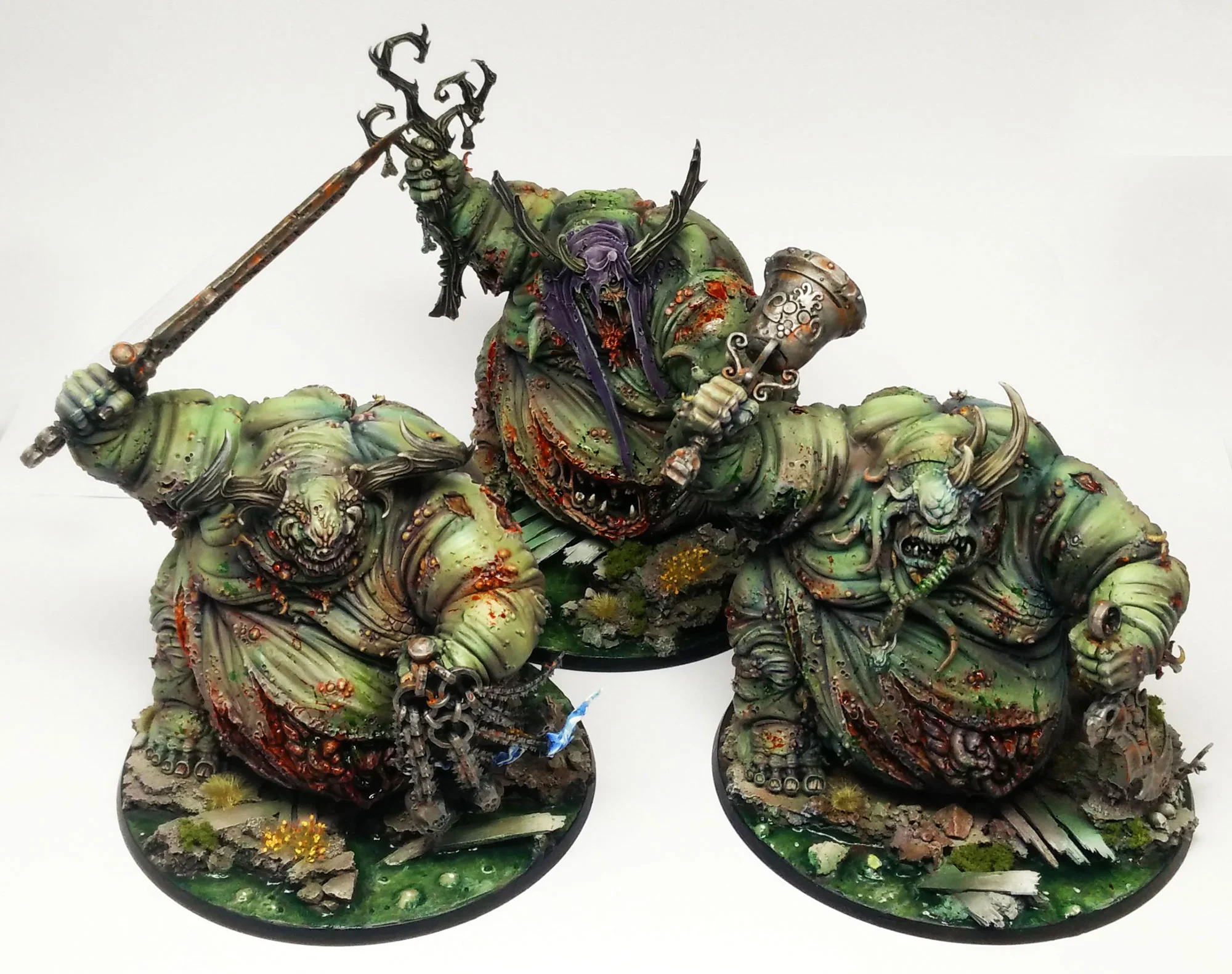 A triumvirate of Nurgle Great Unclean Ones, on swamp bases to add to the atmosphere of blight and decay!