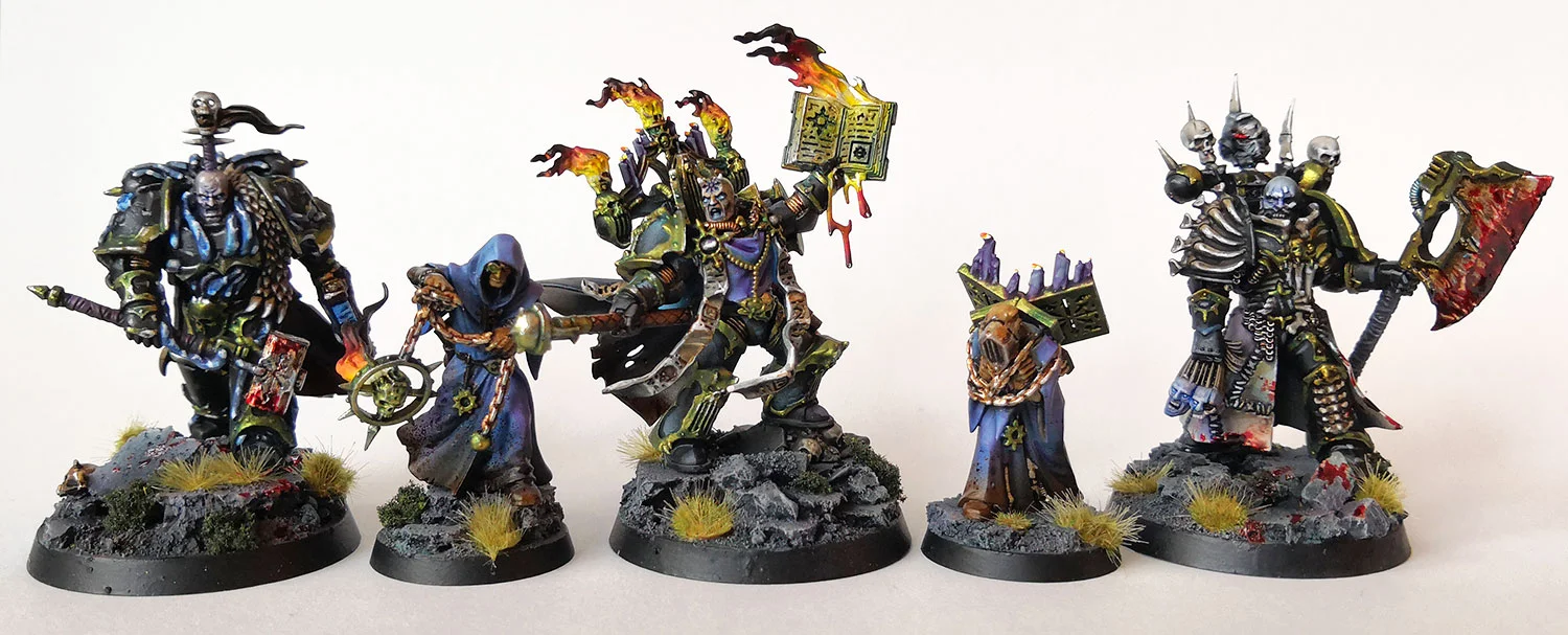 A collection of the newly released Chaos Space Marine miniatures, on rubble bases, with old gold metals and OSL and gore effects.