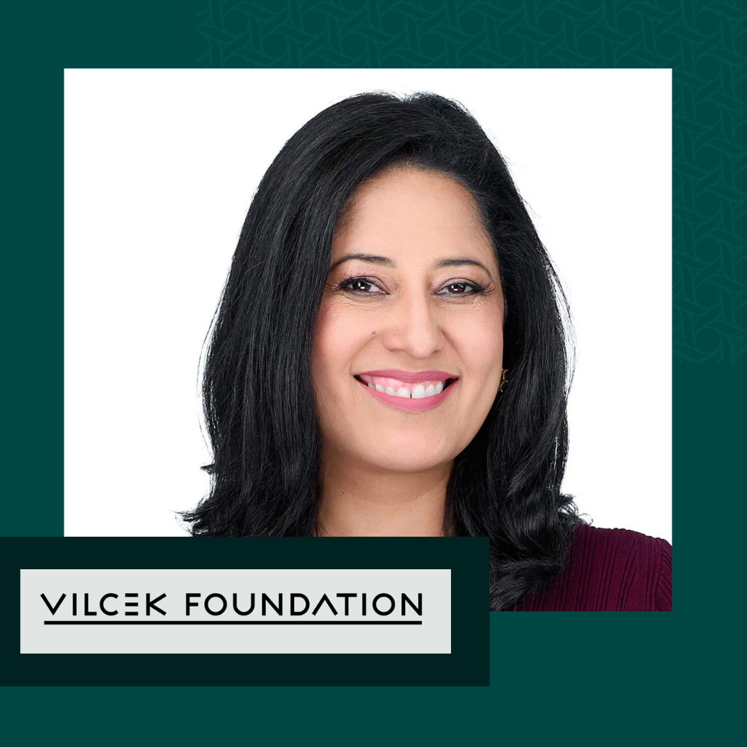 Portrait of a smiling woman with black hair, wearing a maroon top, and the text 'Vilcek Foundation' on a graphic background.