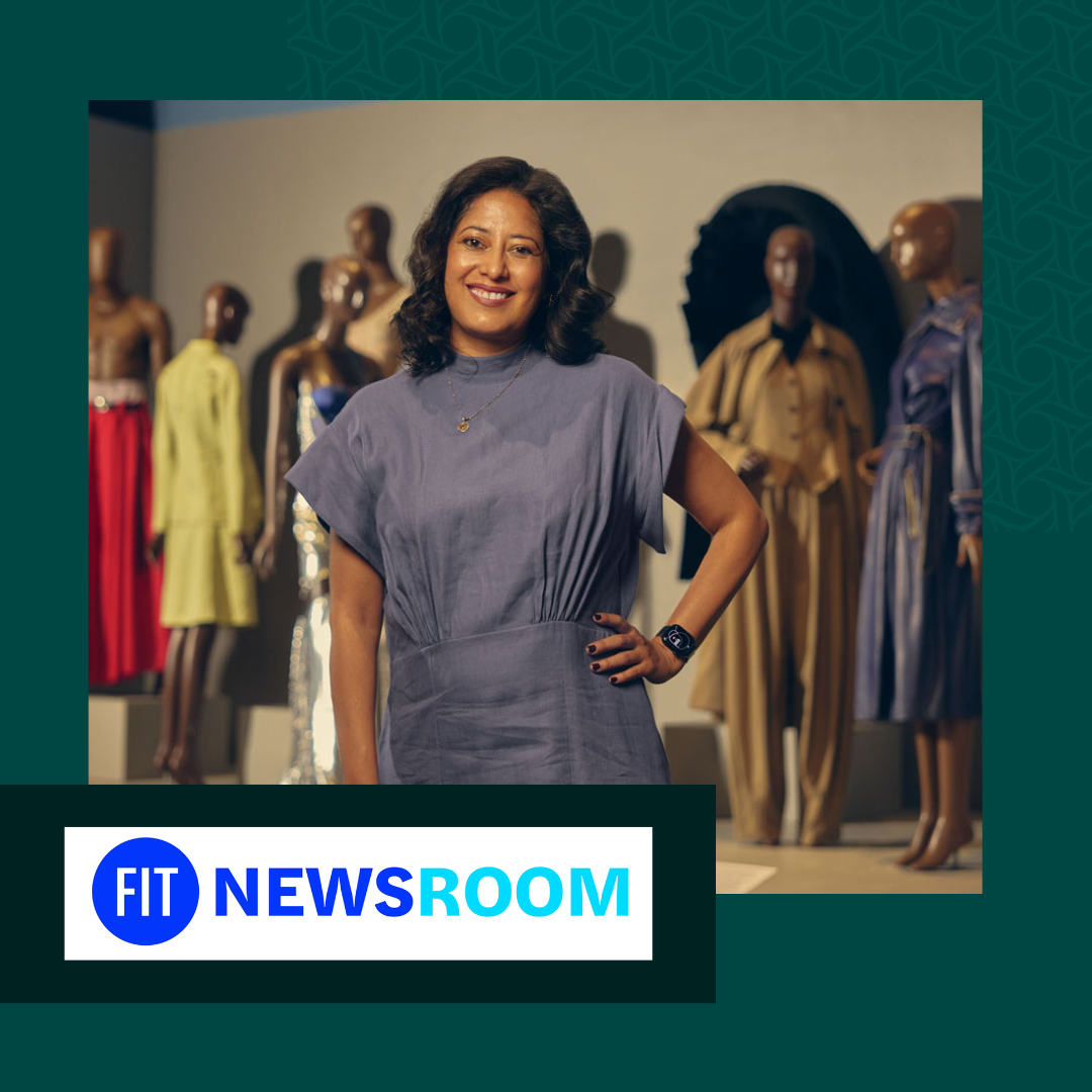 A woman smiling in front of mannequins in a clothing store or exhibition, with various mannequins displaying colorful dresses and outfits in the background.