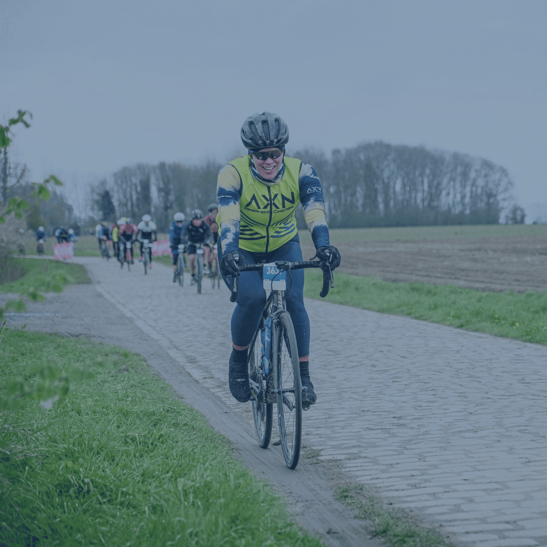 Marissa, a woman on bicycle, in a race in France with other cyclists in background