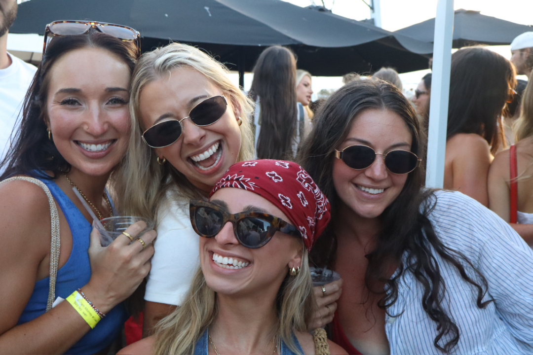 Friends enjoying drinks and live music on Shem Creek at Saltwater Cowboys
