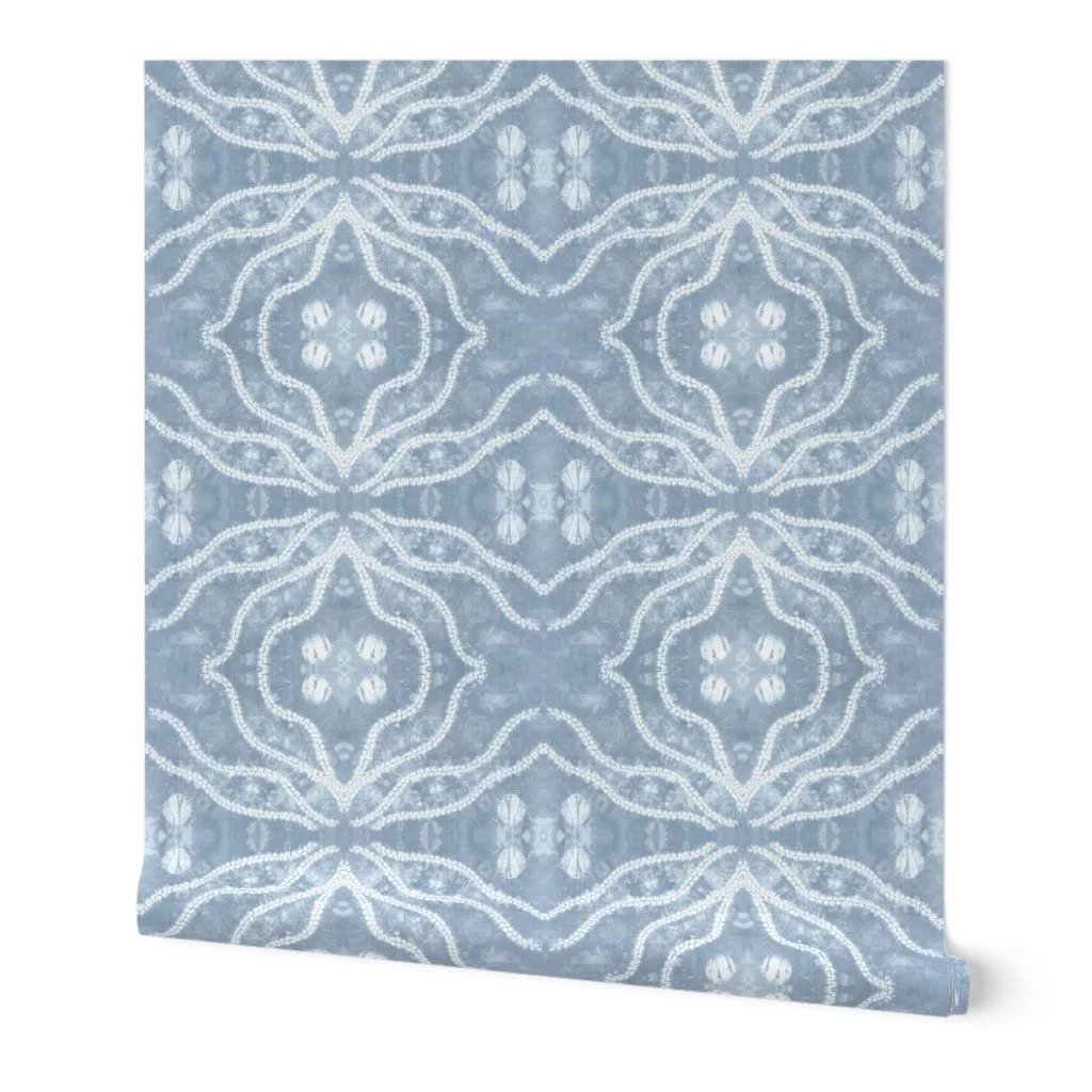 “Roll of navy blue shibori inspired wallpaper showing the detailed hand dyed style pattern.”