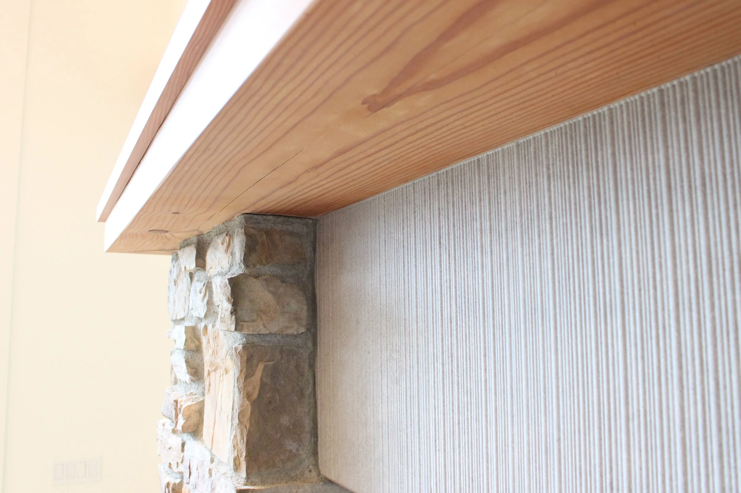 whole-home-remodel-langley-wa-stone-fireplace-mantle-detail.jpg
