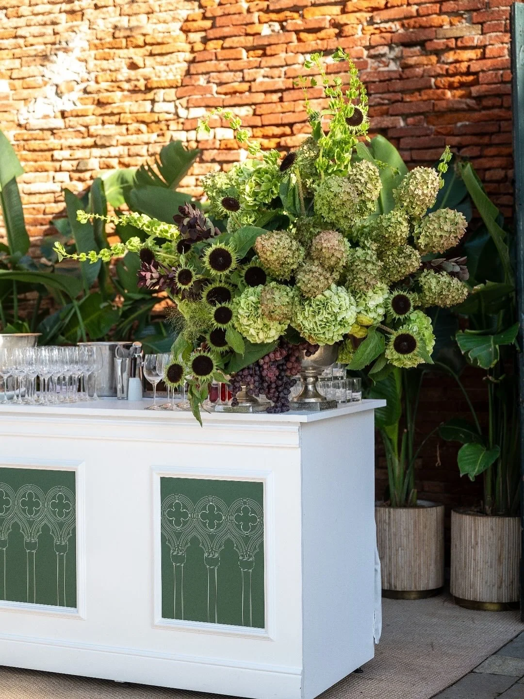 For the final evening&rsquo;s cocktail hour, guests were welcomed into a magical, bright, and airy outdoor space. The statement florals hinted at the mystery of the masquerade gala to follow, while beautifully crafted matchboxes and regal green and g