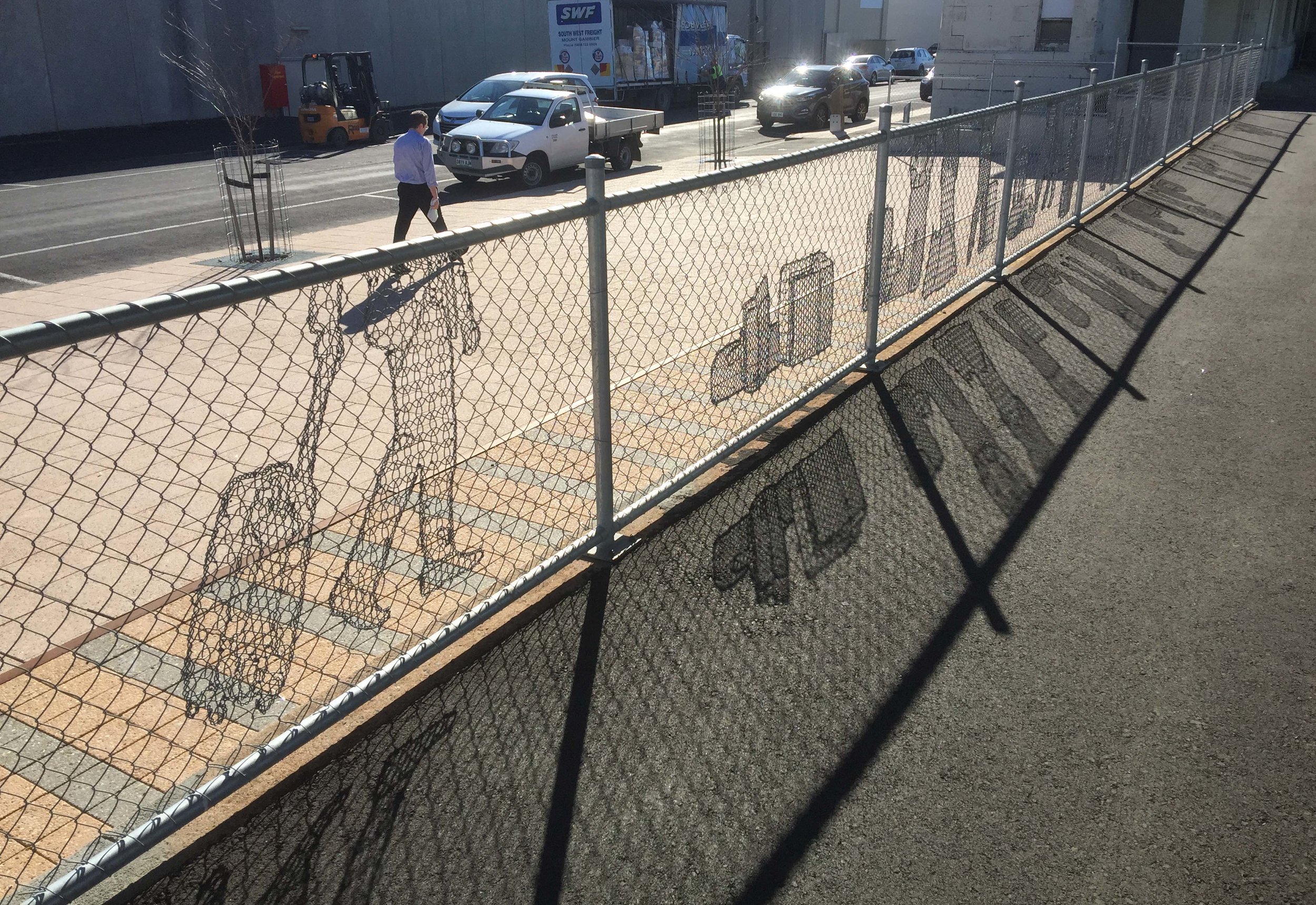   Lace Fence  2015  Permanent public artwork commissioned by Mt Gambier Council.  This artistic design portrays both the modern and historical train platform. Figures can be seen walking, waiting and cleaning the station platform. Other objects are d
