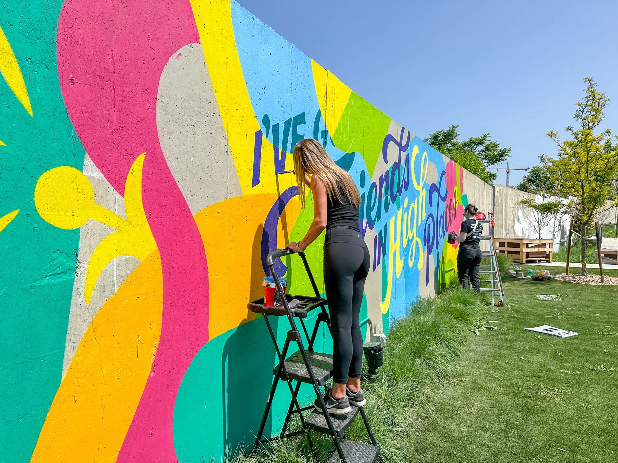 women-painting-floral-typographic-outdoor-mural.jpg
