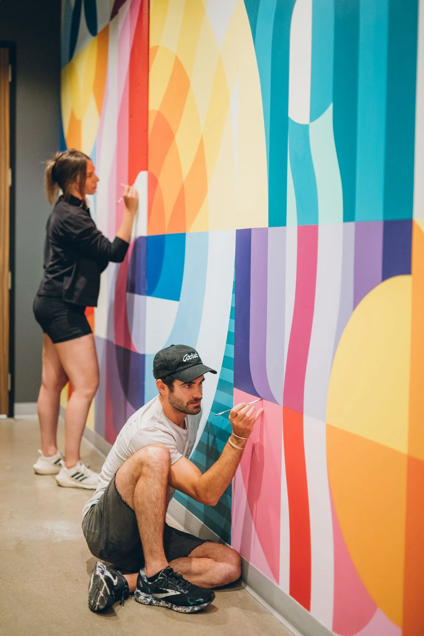 artists-painting-colorful-abstract-mural.jpg