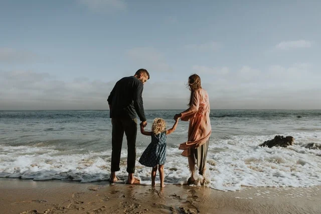 SEGALL-family-happy-at-beach-ocean-waves-min.jpg
