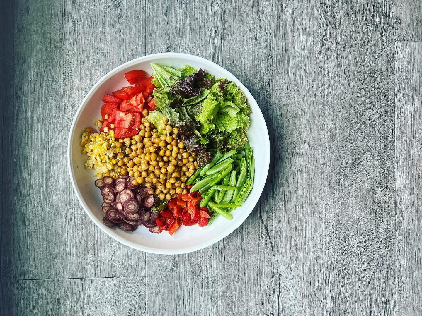 Quick, quick, quick summer salad to have with the artichoke rice casserole &mdash; a head of red romaine, sugar snap peas, roasted red peppers, 3 purple carrots, an ear of leftover grilled corn, a field tomato, and roasted roasted chickpeas