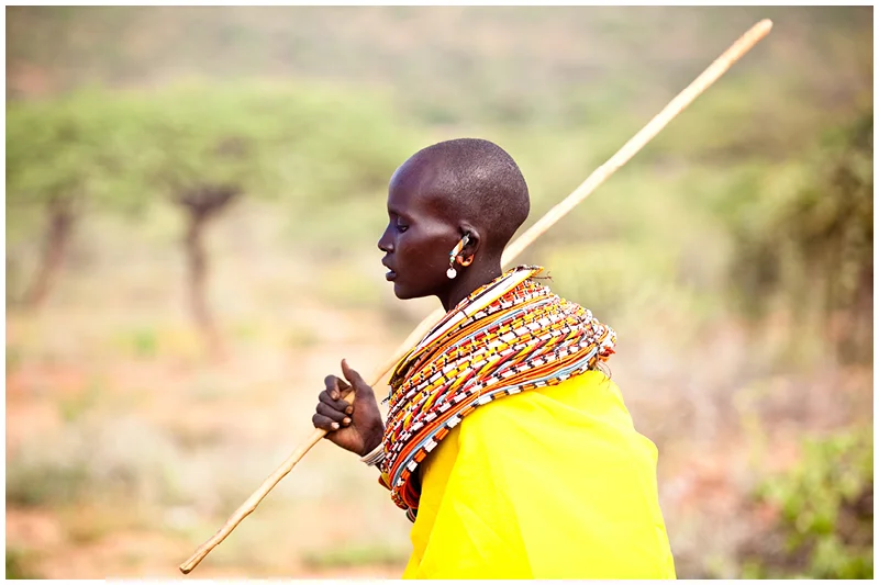 The woman wear these heavy bead collars where ever they go, despite the extreme heat.