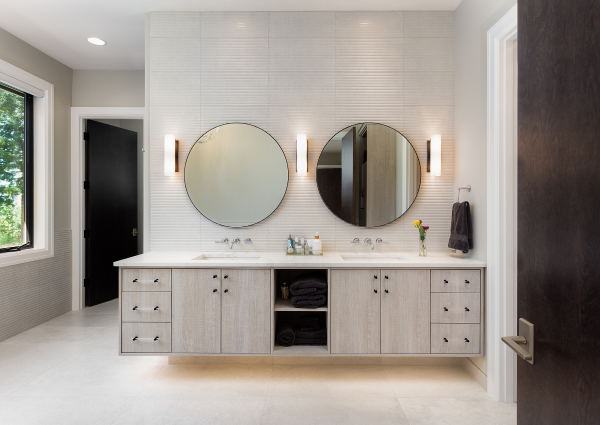 https://images.squarespace-cdn.com/content/v1/5d13d68c02222100019644ff/1632939459333-AEPT3ZURGAT18CB3DU3D/celeste-jackson-interiors-bathroom-storage-organization-minimal-master-bath-with-circle-vanity-mirrors.png