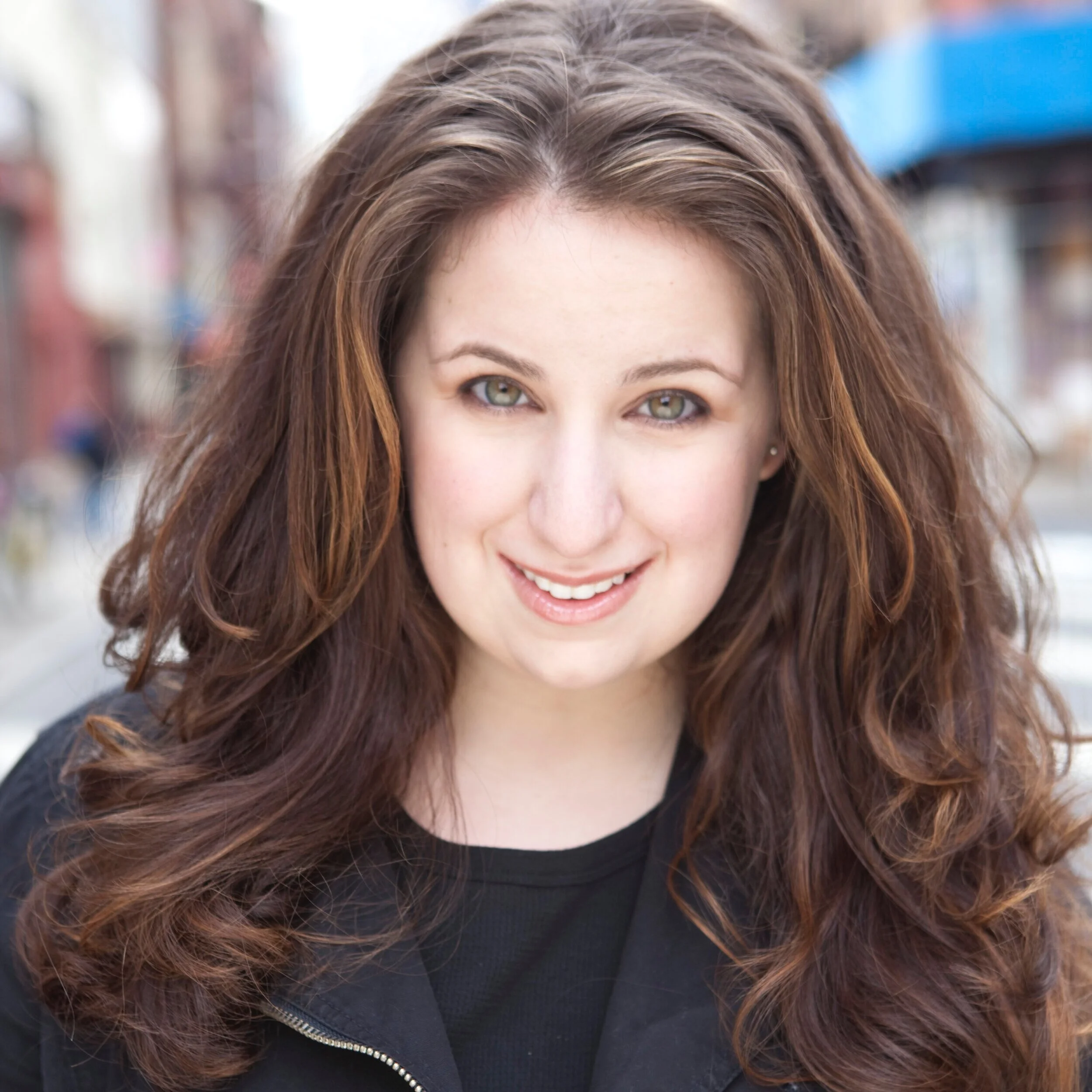 Marisa del Campo, NYC singer, actor, and performance coach wearing all black.