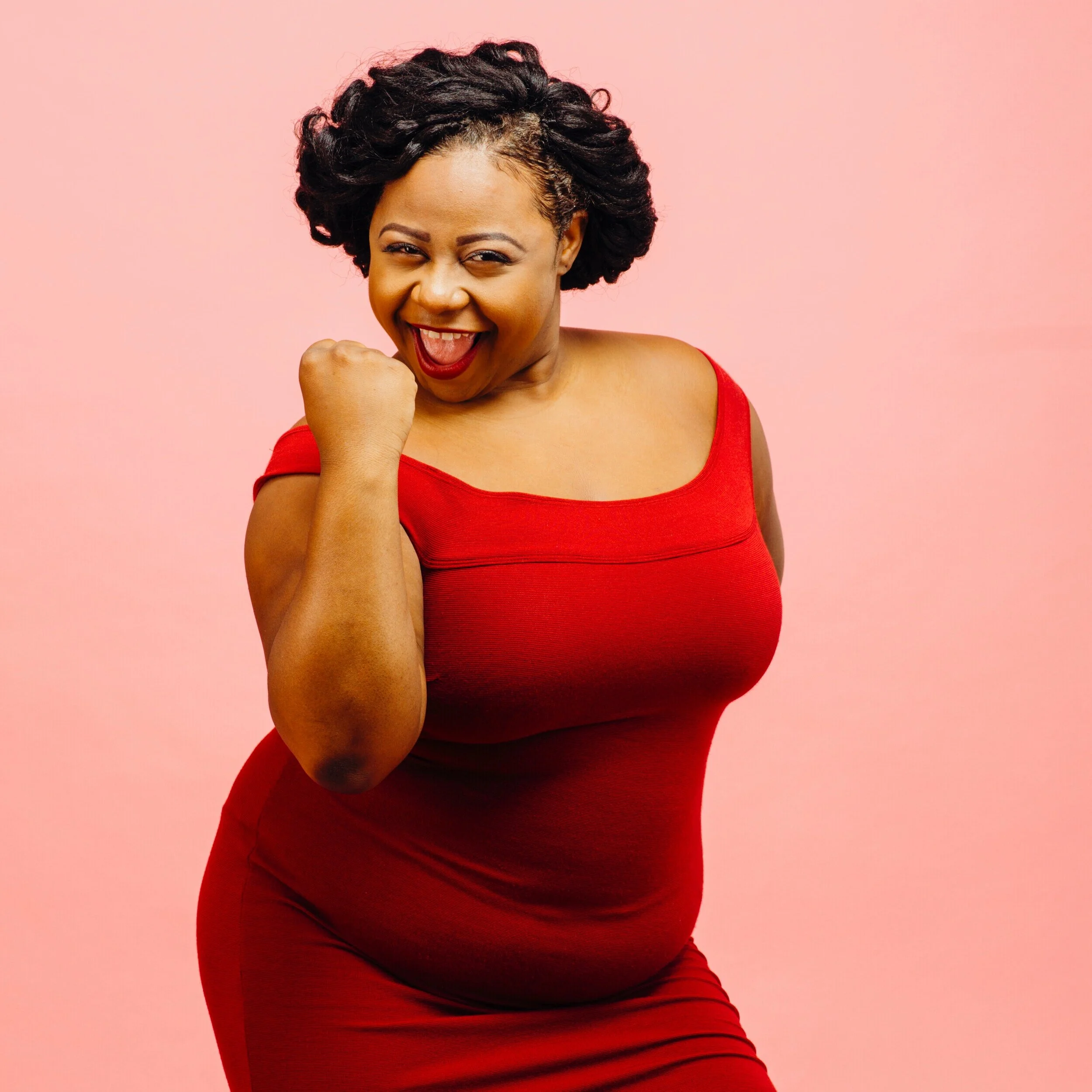 Beautiful black woman performer in red dress celebrating.