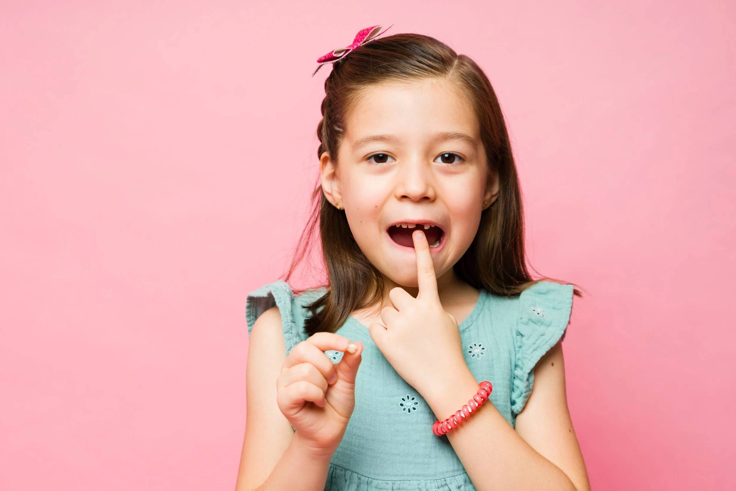 My child's tooth won't fall out. What should I do?