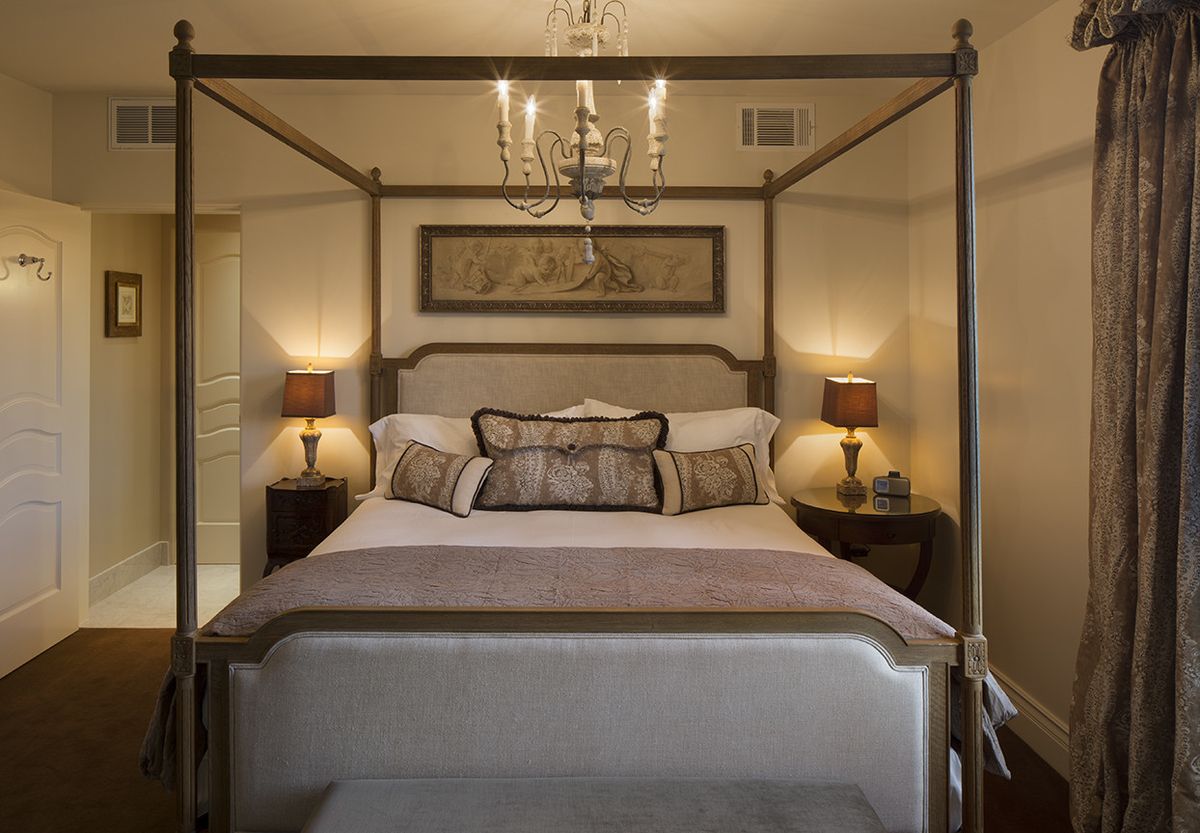 Premier King guest room with four poster bed.