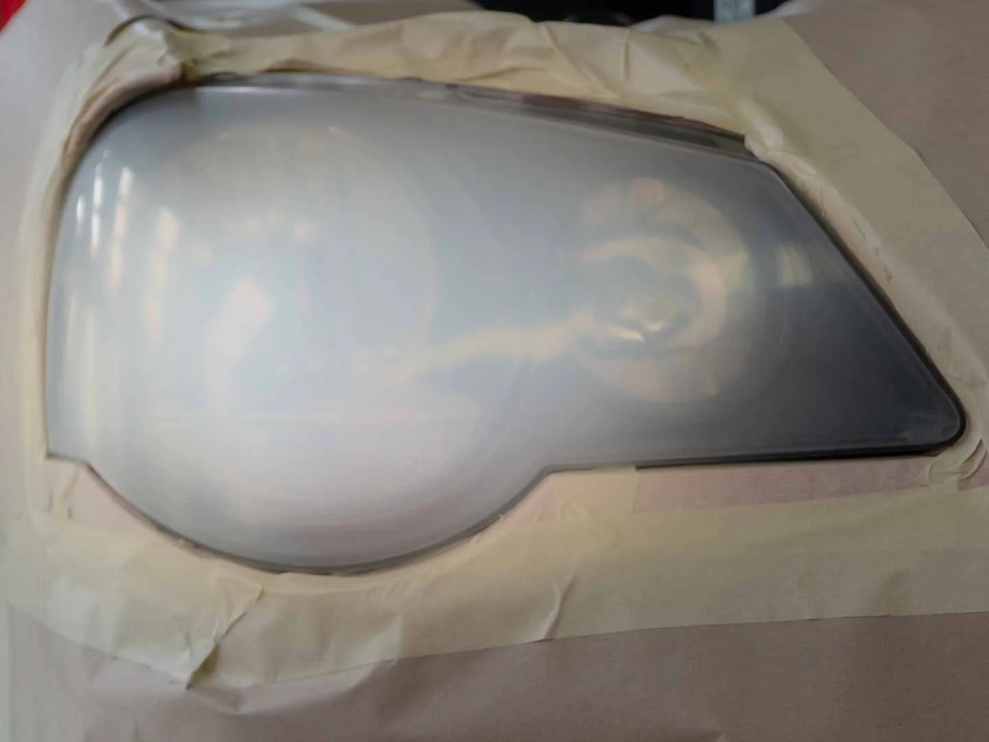 Before headlight restoration showing faded cloudy yellow headlight lens