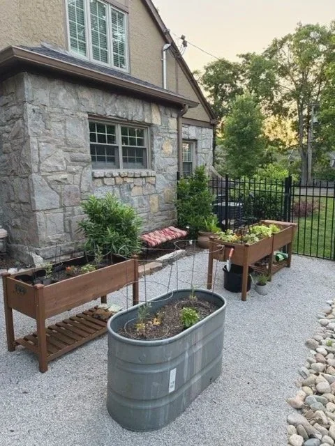 First vegetable garden in Nashville with raised cedar beds and stock tank planter