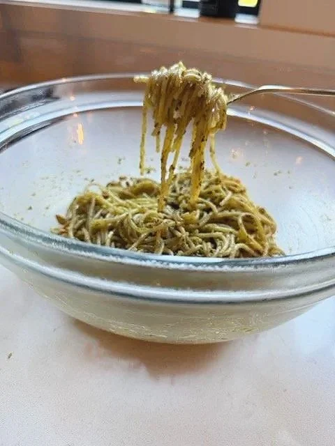 Bowl of pesto spaghetti with pine nuts, easy summer weeknight dinner