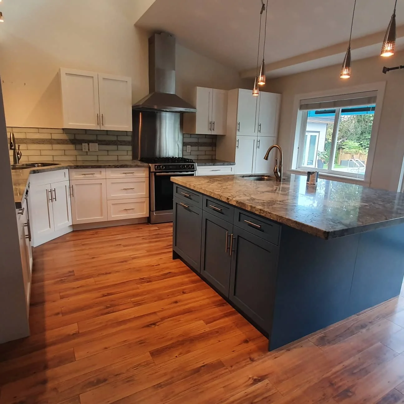 White kitchen cabinetry paired with a blue-gray island.