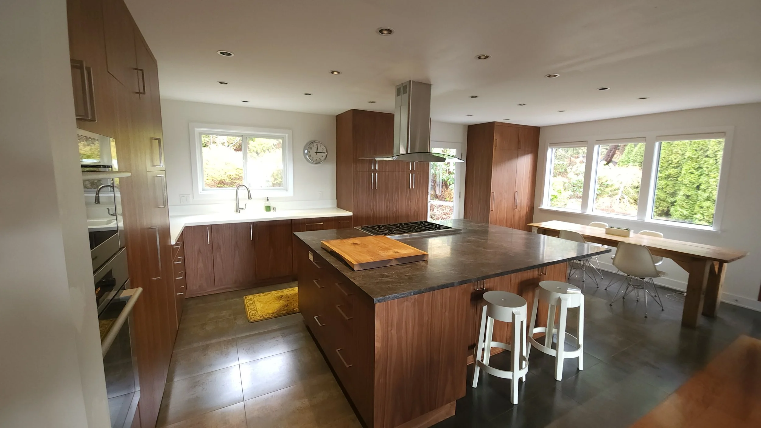 Warm wood grain kitchen cabinetry with clean slab doors.
