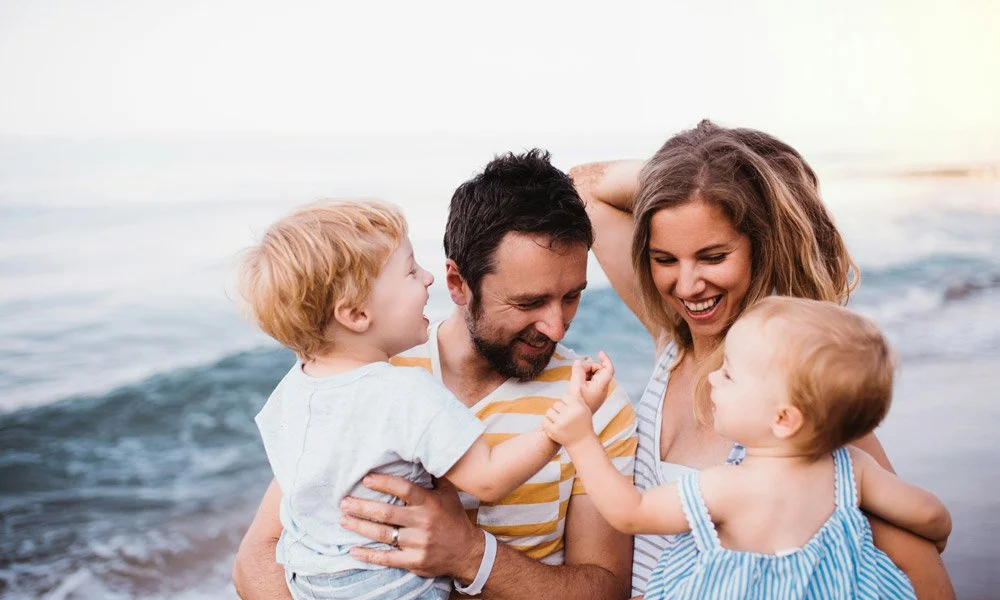 Parents and two kids and the beach