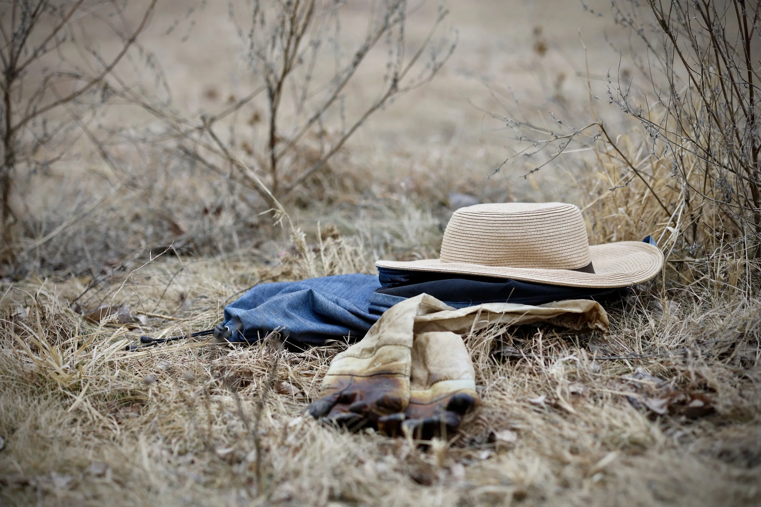 Beekeeping tools resting near winter hives during cold season hive monitoring.