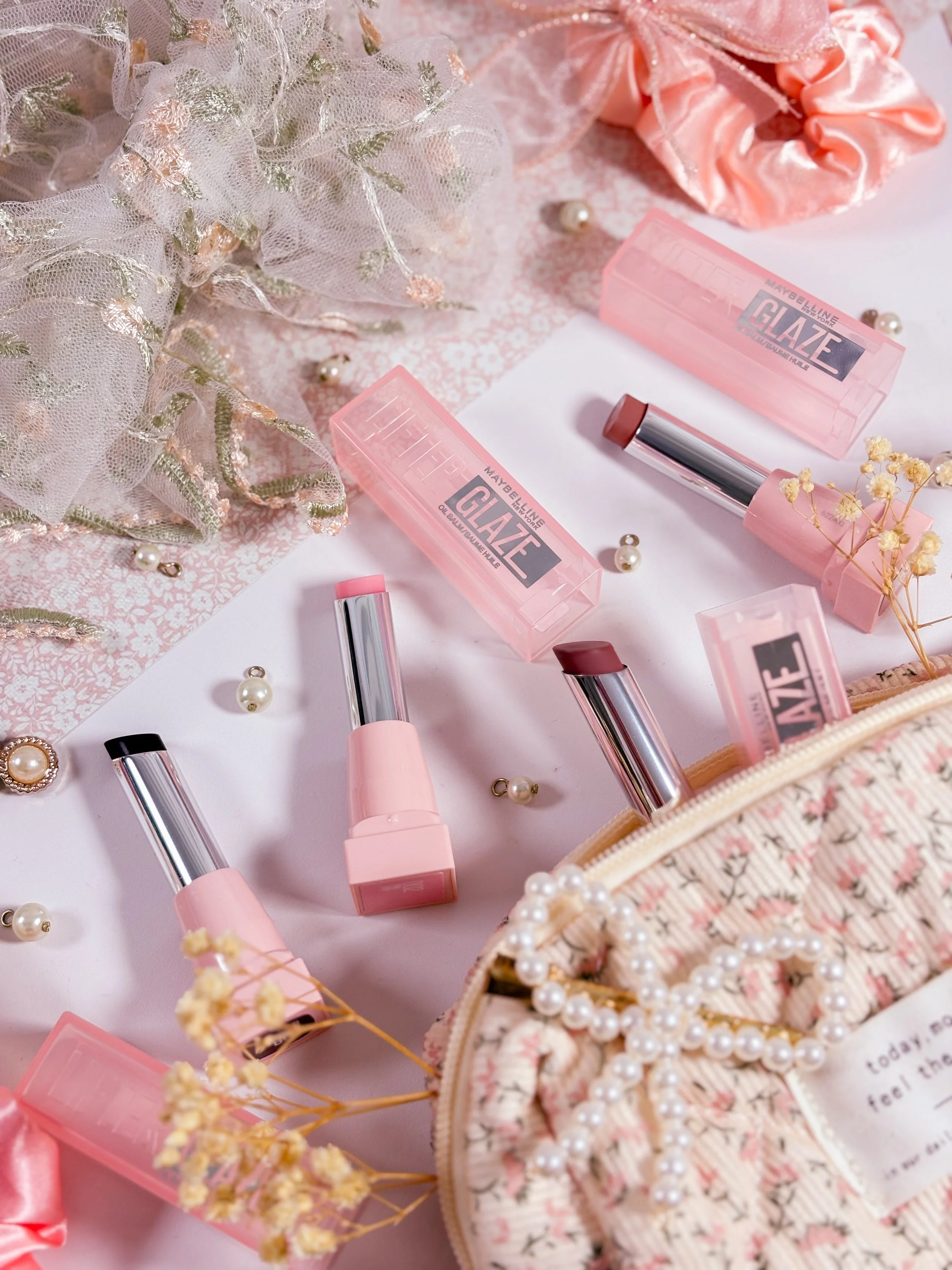 Zoom sur les baumes à lèvres teintés Lifter Glaze de Maybelline en teinte 002 Pink Drip, 006 Caramel Glow, 007 Berry Haze et 008 Acai Glaze