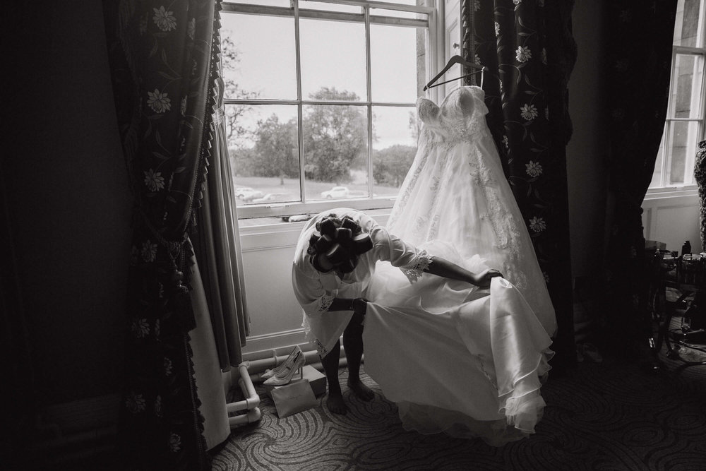 black and white photograph of bride and wedding dress at haigh hall